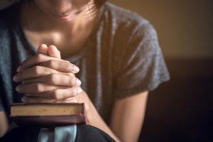 woman praying over bible