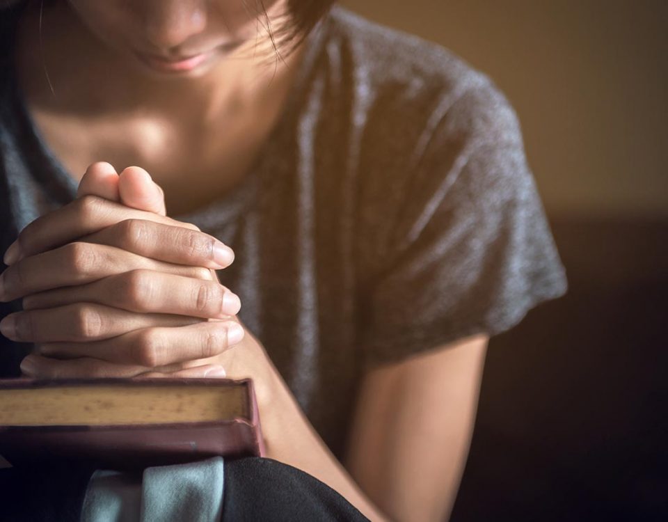 woman praying over bible